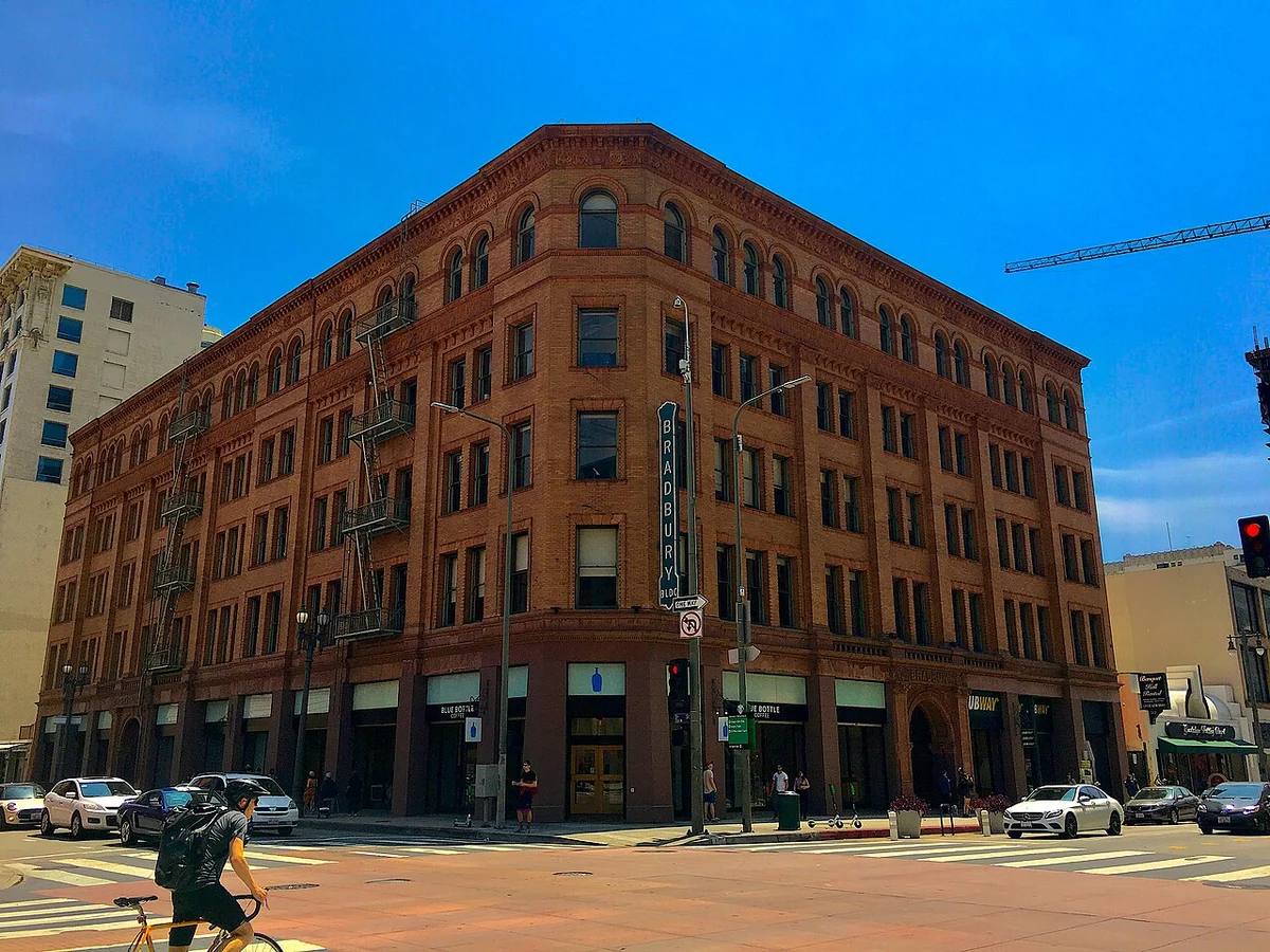 Brick exterior of the Bradbury Building at a Downtown Los Angeles street corner